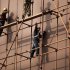 Workers in late afternoon sun walk on the scaffoldings surrounding a newly completed building at the Central Business District in Beijing, China, Monday, Nov. 28, 2011. A top Chinese economics official pledged strong government support Sunday for the country's private businesses, in remarks likely to hearten a sector beleaguered by a credit crunch and downturn in exports. (AP Photo/Andy Wong)