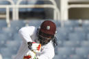 West Indies opening batsman Chris Gayle, right, plays a shot during the second day of their first cricket Test match against New Zealand in Kingston, Jamaica, Monday, June 9, 2014. (AP Photo/Arnulfo Franco)