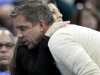 Saints head coach Payton is hugged by Vice Chairman of the Board of the Saints LeBlance during the second half of the Saints-Hornets NBA basketball game in New Orleans