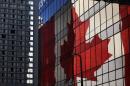 A giant Canadian flag is reflected in a downtown office building on February 6, 2010 in Vancouver, Canada