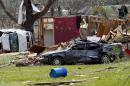 Destroyed automobiles and remnants of homes cover the ground in a south Louisville, Miss., neighborhood, Tuesday, April 29, 2014. A dangerous storm system that spawned a chain of deadly tornadoes over two days flattened homes and businesses, and killed dozens from the Midwest to the Deep South. (AP Photo/Rogelio V. Solis)