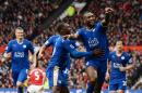 Leicester City's defender Wes Morgan (R) celebrates scoring a goal with Jeff Schlupp (L) during the English Premier League football match between Manchester United and Leicester City at Old Trafford in Manchester, England, on May 1, 2016