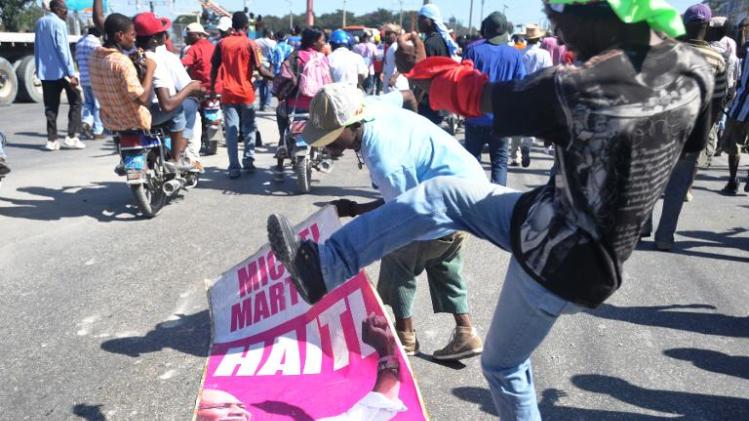 Demonstrators step on a poster with the image of Haitian President Michel Martelly on November 29, 2013 in Port-au-Prince during a protest to denounce what they said was US interference in the country