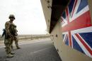 File picture taken on December 16, 2007 shows British soldiers keeping watch as a tank drives by near the airport in Basra, southern Iraq