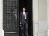 Greek Financial Minister Yannis Stournaras walks off the Premier's office after a meeting with the Greek Prime Minister and the Troika in Athens
