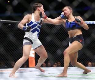 Miesha Tate (R) and Jessica Eye trade punches during their fight in Chicago on Saturday. (AP)