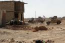 Iraqi security forces and gunmen take position following clashes with jihadists on September 19, 2014, in Ramadi, the capital of Anbar province