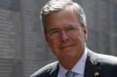 Jeb Bush smiles in front of Memory Wall at Warsaw Uprising Museum
