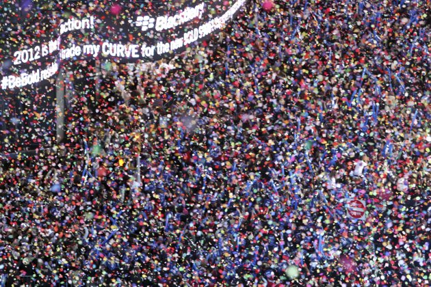 FILE - In this Dec. 31, 2011 file photo, confetti flies over New York's Times Square as the clock strikes midnight during the New Year's Eve celebration as seen from the balcony of the Marriott Marquis hotel. It’s no small task making sure the annual celebration remains safe, but the New York City police use an array of security measures for the event that turns the "Crossroads of the World" into a massive street party in the heart of Manhattan. (AP Photo/Mary Altaffer, File)