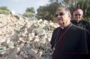 Latin Patriarch of Jerusalem Fuad Tawwal stands amongst the ruins of a Palestinian home, on November 5, 2013