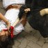 A reveler is tossed by a Dolores Aguirre Yabarra ranch fighting bull during the running of the bulls of the San Fermin festival, in Pamplona Spain, Saturday, July 7, 2012. (AP Photo/Daniel Ochoa de Olza)