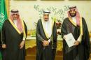 Saudi Crown Prince Mohammed bin Nayef, Saudi King Salman, and Saudi Arabia's Deputy Crown Prince Mohammed bin Salman stand together as Saudi Arabia's cabinet agrees to implement a broad reform plan known as Vision 2030 in Riyadh,