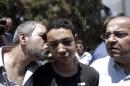 Tariq Abu Khder (centre) is kissed by his father (left) as Ahmed Tibi (right), an Israeli Arab member of the Knesset stands by following a hearing at Jerusalem Magistrates Court on July 6, 2014