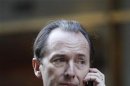 Morgan Stanley CEO Gorman talks on his cell phone after leaving a meeting with lawyer Polk in New York