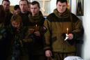 Pro-Russian separatists and relatives attend a religious service of several rebels at their military base in Donetsk, Ukraine on February 16, 2015