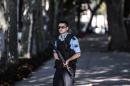 A Turkish police officer patrols at the site where shots were fired at police officers on August 19, 2015 at Dolmabahce palace in Istanbul
