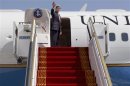 U.S. Secretary of State Kerry waves before boarding a plan headed for Qatar on his first official overseas trip as secretary of state in Abu Dhabi