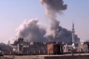 In this image taken from video obtained from the Shaam News Network, which has been authenticated based on its contents and other AP reporting, smoke rises from buildings from heavy shelling in Homs, Syria, on Thursday, Dec. 27, 2012. (AP Photo/Shaam News Network via AP video)