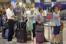 Delta passengers stand in line as the carrier slogged through day two of its recovery from a global computer outage, Tuesday, Aug. 9, 2016, in Salt Lake City. By early afternoon, Delta said it had canceled about 530 flights as it moved planes and crews to 