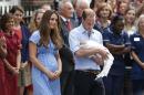 This July 23, 2013 file photo shows Britain's Prince William, right, and Kate, Duchess of Cambridge with the Prince of Cambridge as they pose for photographers outside St. Mary's Hospital in London. Princess Diana wore a caftan-like outfit that hid the post-childbirth tummy bump when William was born. In contrast, the former Kate Middleton, in her first public appearance on July 23, 2013, after giving birth, wore a dress that did not camouflage her belly, and many women are applauding her choice. (AP Photo/Sang Tan, File)