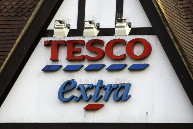 A sign of Tesco supermarket is seen at a branch in Purley, south London, Wednesday, Jan. 16, 2013. The Irish food safety watchdog said Tuesday that it had discovered traces of horse and pig DNA in burger products sold by some of the country's biggest supermarkets. Tesco that authorities said was made of roughly 30 percent horse. Tesco, the country's biggest supermarket chain, took out full-page newspaper ads Thursday Jan. 17, 2013 to apologize for an unwanted ingredient in some of its hamburgers: horsemeat. Ten million burgers have been taken off shop shelves after the revelation that beef products from three companies in Ireland and Britain contained horse DNA. Most had only small traces, but one type of burger sold by Tesco was 29 percent horse. The contrite grocer told customers that "we and our supplier have let you down and we apologize." [AP Photo/Sang Tan)