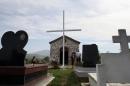People gather in front of the church of the village of Derven, Albania on September 19, 2014