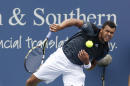 Jo-Wilfred Tsonga, from France, serves to Mikhail Youzhny, from Russia, during a first round match at the Western & Southern Open tennis tournament, Tuesday, Aug. 12, 2014, in Mason, Ohio. (AP Photo/David Kohl)