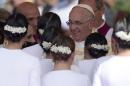 Pope Francis greets dancers after their performance, after he delivered mass to pilgrims at the Marian Shrine of Caacupe on July 11, 2015 in Paraguay