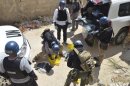U.N. chemical weapons experts prepare before collecting samples from one of the sites of an alleged chemical weapons attack in Zamalka