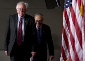 Sen. Bernie Sanders, I-Vt., left, followed by Sen. …