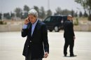 U.S. Secretary of State John Kerry speaks on the phone at Mafraq Air Base before boarding a helicopter to Amman, after visiting Zaatari refugee camp
