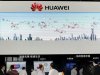 People visit the Huawei booth at a communication technologies exhibition in Beijing