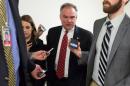 Senator Tim Kaine (D-VA) speaks to reporters as he walks to the Senate Chamber to vote on legislation for funding the Department of Homeland Security