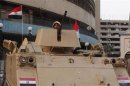 An Egyptian army soldier stands guard in front of the state television building in Cairo