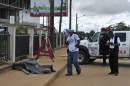 Police carry out forensic testing for the Ebola virus on a corpse found on a street in Monrovia