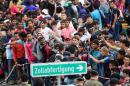 Refugees crowd at the Hungarian-Austrian border in Szentgotthard, Hungary, as thousands of migrants wait for their departure to Germany on September 19, 2015