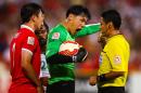 Wang Dalei (C), goalkeeper of China, shouts at referee Alireza Faghani of Iran during their first round Asian Cup match against Saudi Arabia, at the Suncorp Stadium in Brisbane, on January 10, 2015