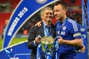 Then-Chelsea's manager Jose Mourinho (L) and Chelsea's captain John Terry (R) celebrate with the League Cup trophy on March 1, 2015