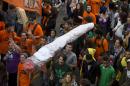Demonstrators carry a fake marijuana joint at a legalization of marijuana march in Sao Paulo, Brazil, Saturday, April 26, 2014. Brazilian police say about 2,000 people have gathered in downtown Sao Paulo in a demonstration demanding the legalization of the production and sale of marijuana in Latin America's largest country. (AP Photo/Andre Penner)