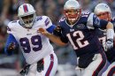 New England Patriots quarterback Tom Brady is blocked by Buffalo Bills defensive end Marcell Dareus after throwing an interception during the second quarter of their NFL football game in Foxborough