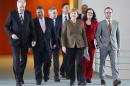 German Chancellor Merkel and her ministers arrive for a security meeting at the Chancellery in Berlin
