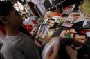 A Syrian man looks at campaign posters of President Bashar al-Assad displayed on a stall at a market in the capital Damascus, on June 1, 2014