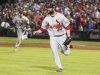 Cardinals pitcher Motte and his teammate Craig run off the field as they celebrate their win over the Atlanta Braves for the wild card at their MLB National League Wild Card playoff baseball game in Atlanta