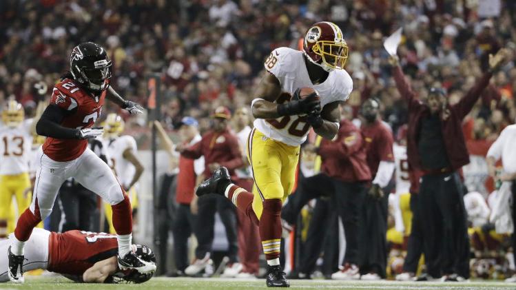 Washington Redskins wide receiver Pierre Garcon (88) makes a catch against Atlanta Falcons cornerback Desmond Trufant (21) during the first half of an NFL football game, Sunday, Dec. 15, 2013, in Atlanta. Moss scored a touchdown on the play