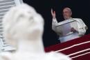 Pope Francis blesses the faithful during his Sunday Angelus prayer on the feast of the Assumption, the day Catholics celebrate Mary's rise into heaven, in Vatican