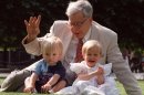 FILE- The British pioneer of IVF treatment, Professor Robert Edwards sits with two of his 'test-tube-babies', Sophie and Jack Emery who celebrate their second birthday in London in this file photo dated Monday July 20, 1998. The Nobel prize winner for medicine, Edwards who was a pioneer of in-vitro fertilization, which became known as test tube babies, has died aged 87, it is announced Wednesday April 10, 2013. (AP Photo/Alastair Grant, File)