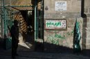 A rebel stands at the entrance to a Mamluk-era mosque in Aleppo