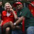 British entrepreneur Richard Branson, left, poses with AirAsia's Chief Executive Tony Fernandes while dressed up as an AirAsia flight attendant at a low cost carrier terminal in Malaysia, Sunday, May 12, 2013.  Branson wore the costume after losing a bet with his friend Fernandes on which of their 2010 Formula One racing car teams would finish ahead of the other. (AP Photo/Vincent Thian)