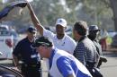 Tiger Woods loads his car after withdrawing in the first round of the Farmers Insurance Open golf tournament Thursday, Feb. 5, 2015, in San Diego. (AP Photo/Gregory Bull)
