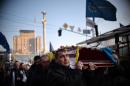 Members of a self-styled Maidan self-defence unit carry the coffin of Vasil Sheremet, 65, mortally wounded in the recent clashes with the riot police, at the Independence square, in central Kiev on March 7, 2014